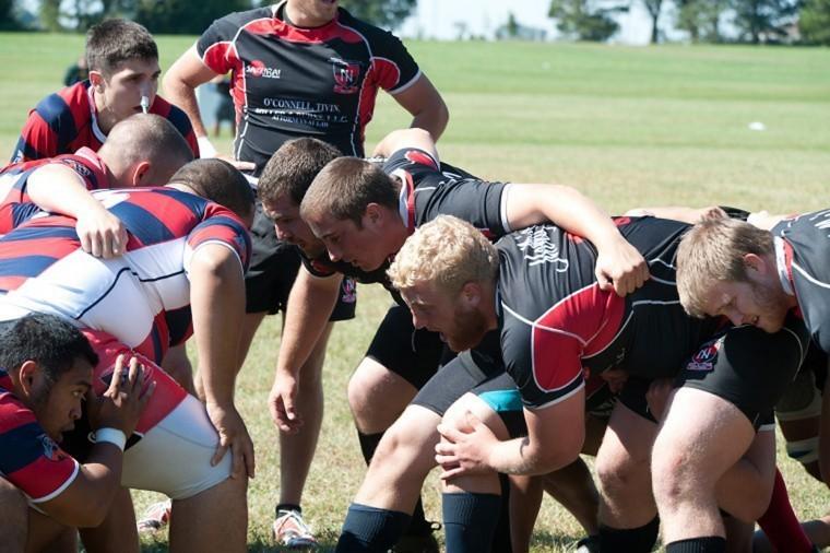 Members of the NIU mens rugby team enter into a scrum against
UIC last fall.
