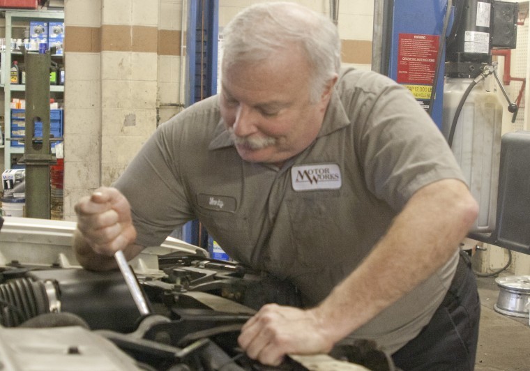 Marty Fay, owner of Motor Works 316 E. Taylor Street, works on a
car Tuesday afternoon. The shop was recently awarded for one of the
top ten websites in the automotive industry.
