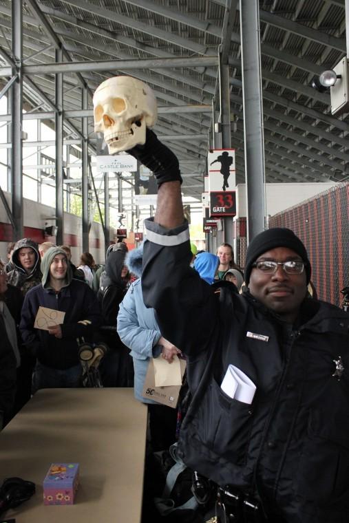 Officer Dana Brisbon displays a replica skull at the NIU Police Auction on Saturday morning. The auction, which was held under the student bleachers of Huskie Stadium, auctioned off a variety of items, including bicycles, iPods, and purses. The proceeds were donated back to NIU.
