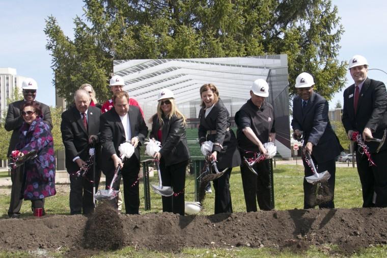President John Peters, leadership donors Dennis and Kimberly Yordon and Kenneth and Ellen Chessick, representatives of the Board of Trustees, and Athletic Director Jeff Compher break ground Saturday morning for the new Dr. Kenneth and Ellen Chessick Practice Center on the north side of Huskie Stadium.

