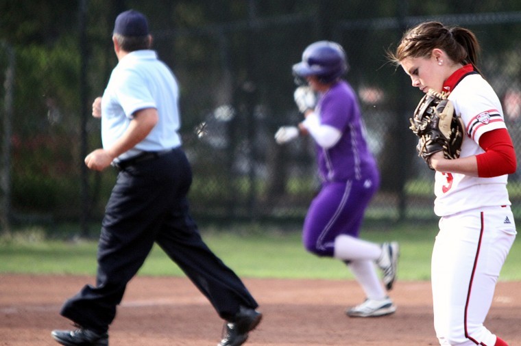 NIU pitcher Allyson Hecht returns to the mound as Northwestern first baseman Adrienne Monka rounds third following her first of two home runs. Monka was 3-for-3 with 5 RBIs in the Cats victory over the Huskies.
