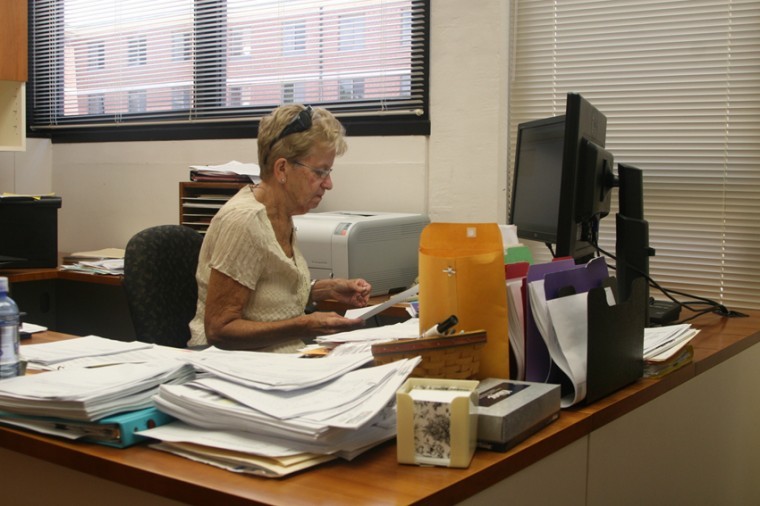 Office Manager Pat Siebrasse looks up forms for a faculty member at the School of Family, Consumer and Nutrition Sciences in Wirtz Hall.
