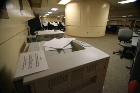 A pile of papers sit on a printer at the Douglas computer lab in 2011.