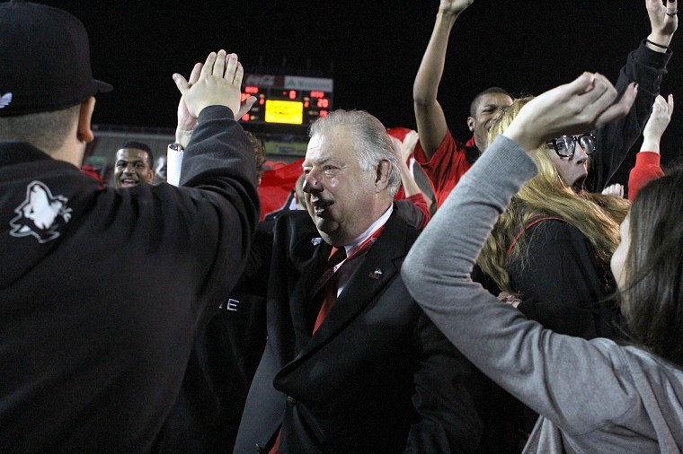 NIU president John Peters high-fives fans after the Huskies
victory in the GoDaddy.com Bowl.

