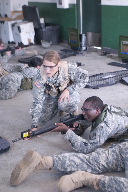 Cadet Company Cmdr. Lauren Armendariz-Bast (MSIII) (left) coaches Jules Ruremesha as he operates his weapon while learning from simulation software during field training. Members of the ROTC participated in various training activities throughout the weekend.
