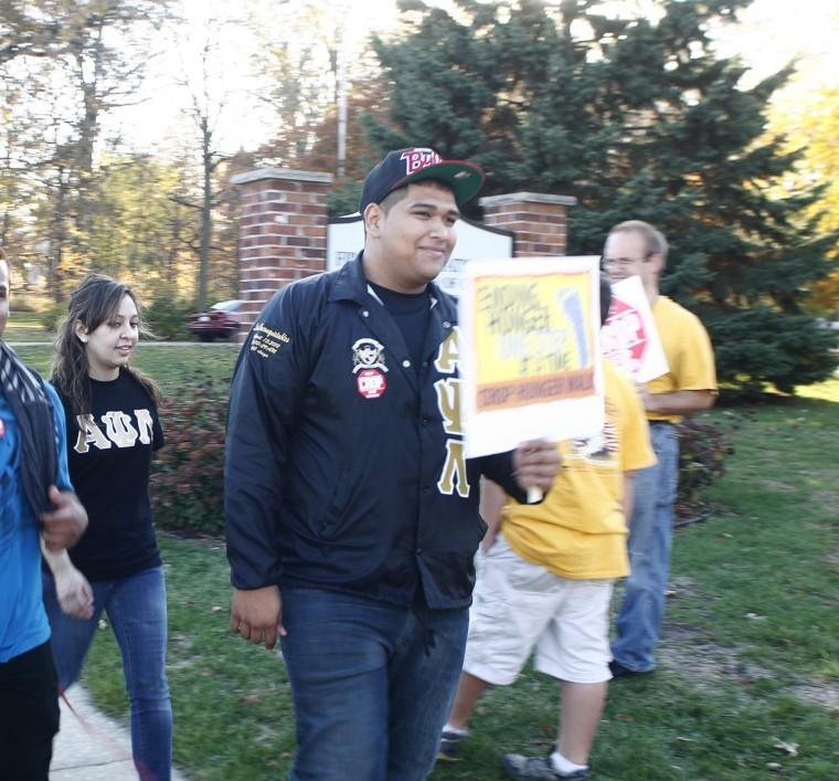 Andres Luvianos, sophomore mechanical engineering major, crosses the finish line of the CROP Walk at the First Congressional Church in DeKalb, Ill. The CROP Walk is a fundraising walk organized in order to raise money to end hunger and poverty.
