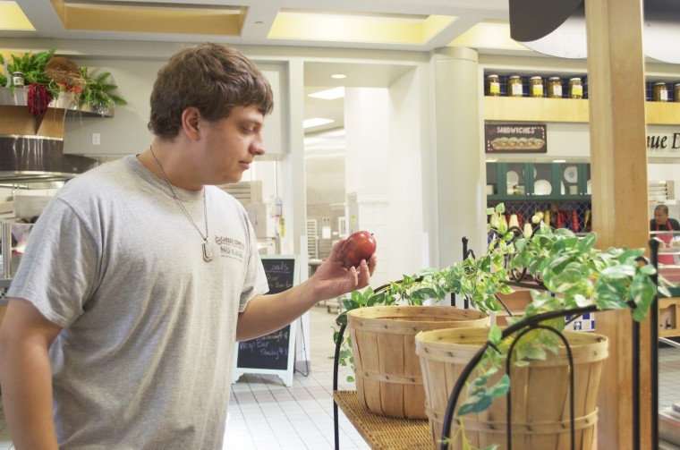 Former Northern Star Sophomore accounting major Goran Ikanovic picks up an apple in the Stevenson dining hall. Stevenson’s dinning center has a variety of healthy food choices for students to choose from.
