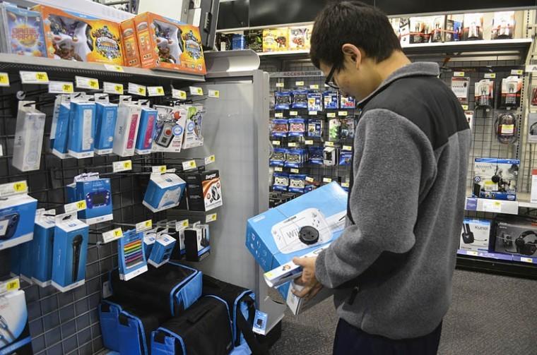 Sophomore English major Hantac Chang decides on if he should purchase the Wii-U at the Best Buy on Sycamore road.
