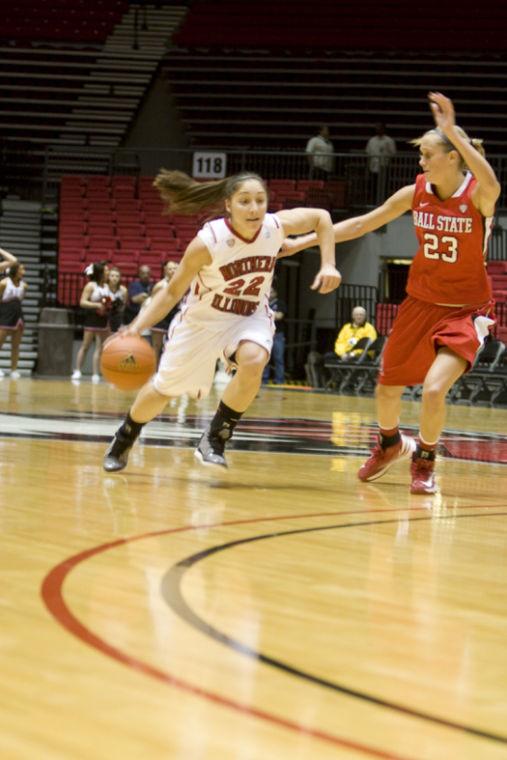 James McCarter | Northern Star Sophomore guard Amanda Corral brings the ball up the court against a Ball State defender.
