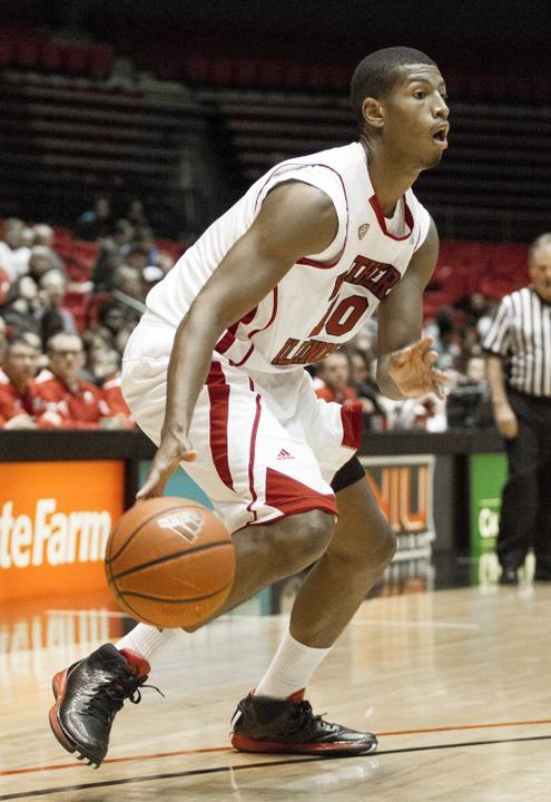 Freshman Forward Darrell Bowie for Northern Illinois University makes a crossover toward the basket.
