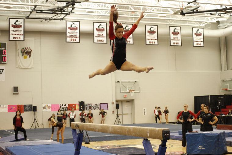 NIU Gymnast, Sophomore Amanda Stepp, performs a split jump on the beam event at the 2013 season opener against Illinois State University at the Convocation Center Sunday afternoon.
