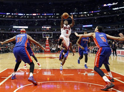 Chicago Bulls guard Nate Robinson (2) shoots between Detroit Pistons forwards Charlie Villanueva (31) and Austin Daye (5) during the first half of an NBA basketball game, Wednesday, Jan. 23, 2013, in Chicago. (AP Photo/Charles Rex Arbogast)

