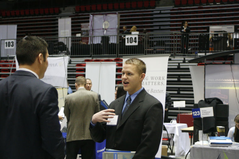 Senior finance major, Kevin Rogina talks with a recruiter from New York Life Insurance Company about employment opportunities at the Job Fair held in the Convocation center on Wednesday.
