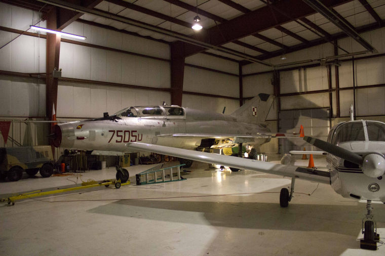 A 1975 Mig 21 (left) and a Piper Warrior II (right side) inside a hangar at the Dekalb Taylor Municipal Airport.
