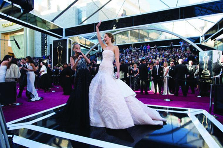 Jennifer Lawrence (R), Oscar®-nominee for Actress in a Leading Role, interviews with Kristin Chenoweth (L) upon her arrival for The Oscars® at the Dolby® Theatre in Hollywood, CA February 24, 2013.
