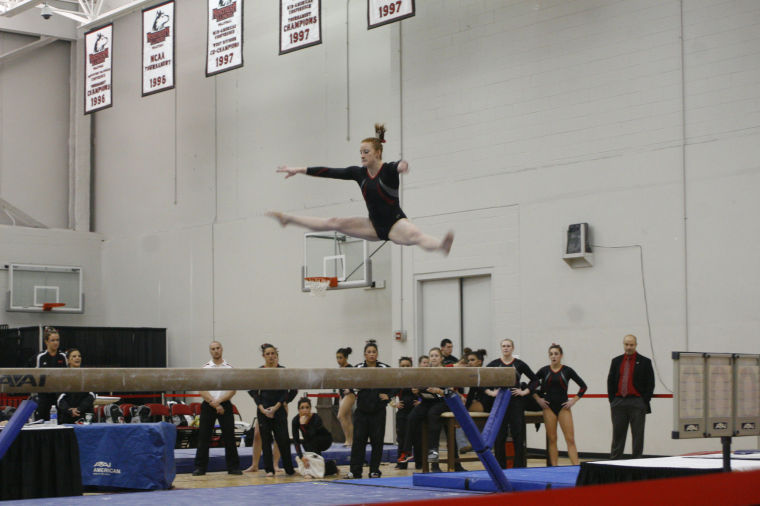 Senior Natalie Sutter performs a split jump on the balance beam in the gymnastics meet against Southeast Missouri State University on Saturday.
