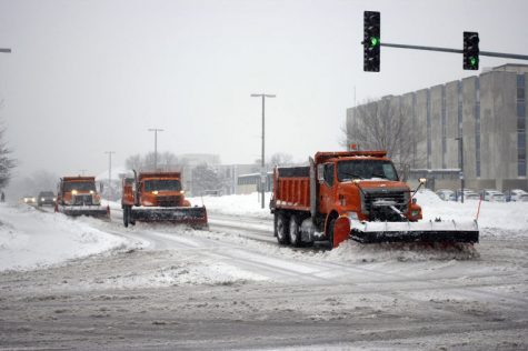 DeKalb snowplows plow Lucinda Ave. during the heavy snowfall on Monday, which caused Northern Illinois University to cancel all classes after 12:30pm.