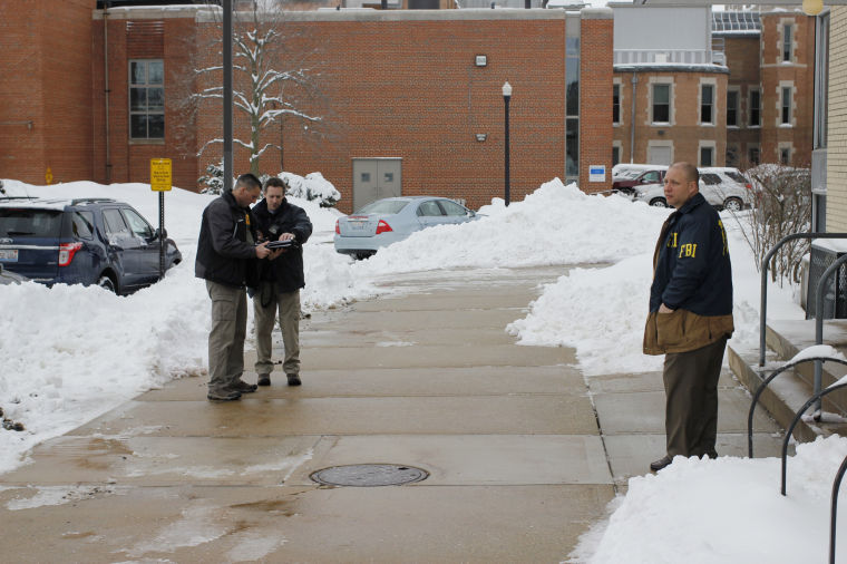 FBI agents stand outside of the NIU Campus Police Station while executing a search warrant on Wednesday morning.
