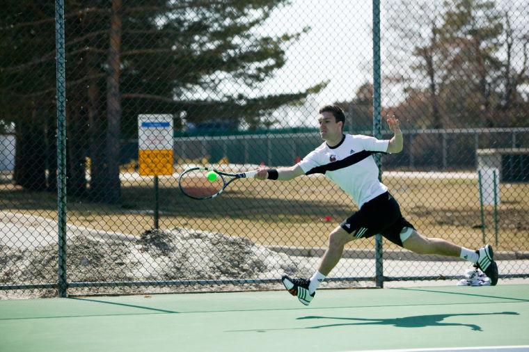 Senior Max Phillips scores a point in a March match against Western Michigan University.
