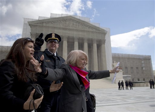 Plaintiff Edith Windsor of New York waves to supporters in front of the Supreme Court in Washington, Wednesday, March 27, 2013, after the court heard arguments on the Defense of Marriage Act (DOMA) case. The U.S. Supreme Court, in the second day of gay marriage cases, turned Wednesday to a constitutional challenge to the federal law that prevents legally married gay Americans from collecting federal benefits generally available to straight married couples. (AP Photo/Carolyn Kaster)
