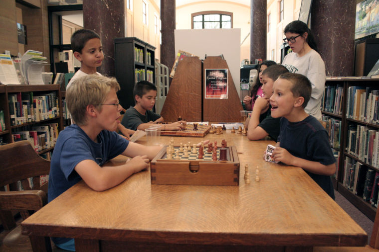 Young Harry Potter fans enjoy a game of chess Tuesday at the Harry Potter Party held at the DeKalb Public Library, 309 Oak St. in a reenactment of the chess theme prevalent in the first book, The Sorcerers Stone.