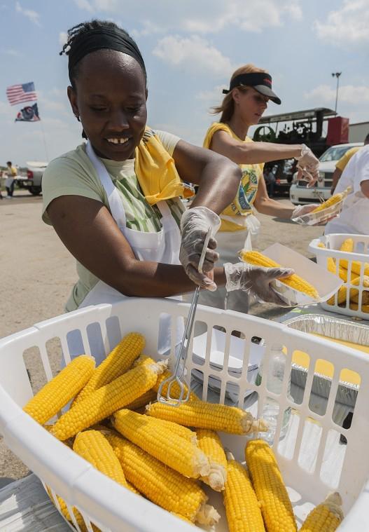 Callie Beckford, 31, of DeKalb hands out free DeKalb corn during the Corn Boil held at the DeKalb Taylor Municipal Airport during Corn Fest on August 25, 2012.