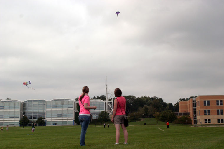 Christina Pawlak (left) and Jessica Holm, both elementary education alumnae, enjoy the time flying their kite Sunday at DeKalbs eighth annual Kite Fest held at NIUs North 40 field at the corner of Lucinda Avenue and Kishwaukee Drive.