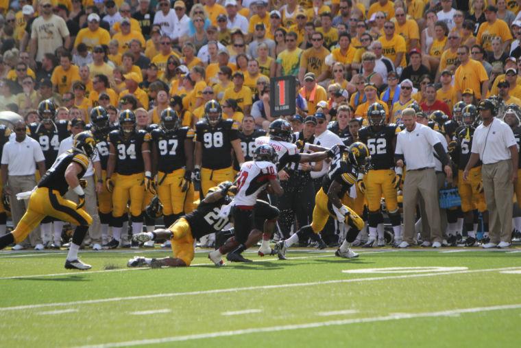 Junior wide out TommyLee Lewis about to be tackled by a Hawkeye defender late August at Kinnick Stadium. NIU will face the Vandals in their second match of the season on Saturday.