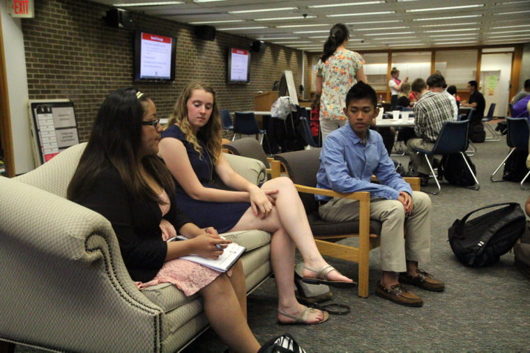 Lizabeth Roman, sophomore community leadership & civic major, Kathryn Voight, freshman history major, and Zharfan Irawan, accounting major, gather together Monday night to discuss their various research topics in their classes at the Founders Memorial Library during the monthly Research Rookies meeting.