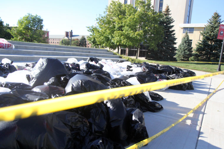 Garbage bags filled with newspapers line the steps of the Martin Luther King Commons Monday as part of the Save Chicago campaign. The bags signify the 506 people that have died due to violence in 2012 while the newspapers represent their untold stories.