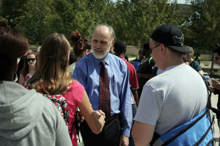 President Doug Baker (center) talks to members of the NIU community Wednesday during his ice cream social, which was held at the MLK Commons. Students and staff gathered to greet to the president and were treated to root beer floats as they waited.