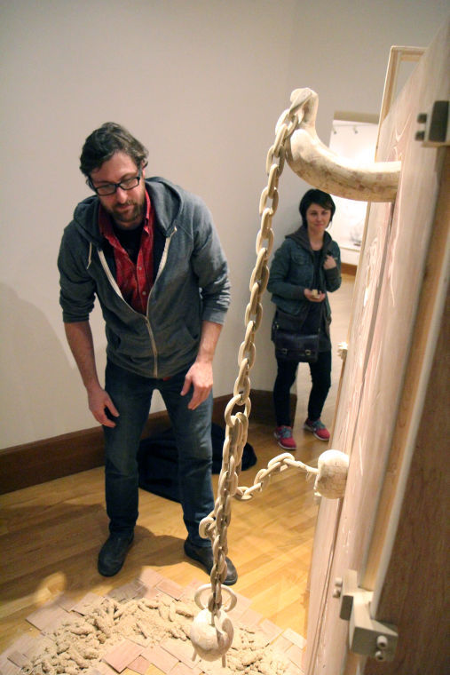 Michael+Rea%2C+assistant+professor+and+artist%2C%C2%A0explains+the+details+of+his+sculpture+entitled+Quid+Pro+Quo+made+from+wood%2C+pink+foam%2C+wood-fill+and+rope+during+Nov.+21s+%C2%A0School+of+Art+Faculty+Exhibition+at+Altgeld+Hall.