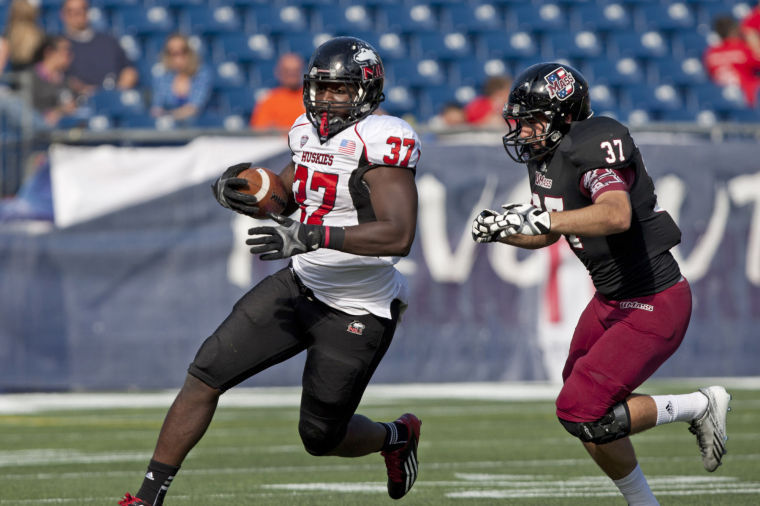 Sophomore Desroy Maxwell (37) carries the ball down field during Saturdays game against Massachusetts. NIU won 63-19.
