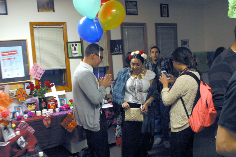 The Latino Resource Center hosted a Day of the Dead gathering and festivity Thursday. Marycarmen Ruiz (center), junior communicative disorders major, dressed as painter Frida Kahlo for the festivities.