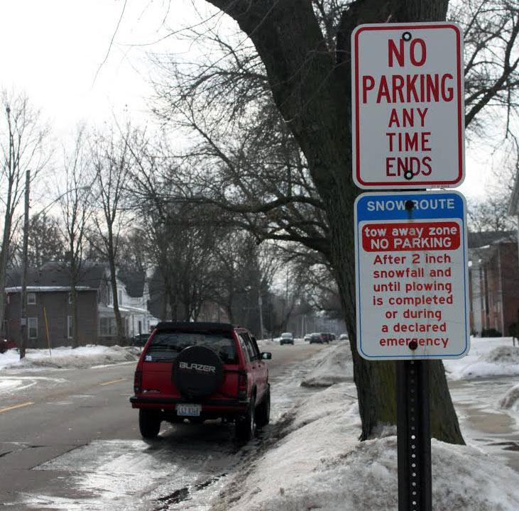 A car is parked on First Street near an indicated seasonal tow-zone sign. Police are encouraging residents to obey these signs and to take precaution during the winter.