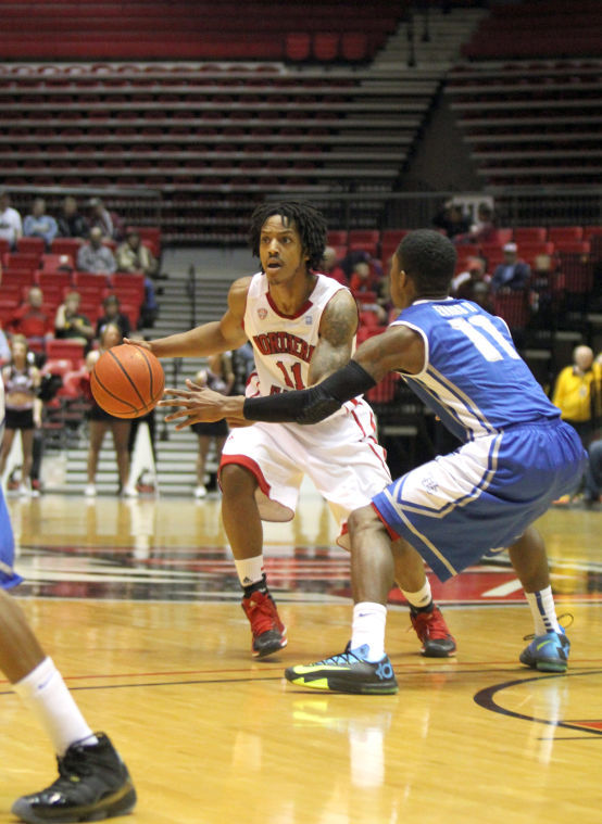 Sophomore Daveon Balls (11) hurries the ball down the court during Saturdays loss against Buffalo at the Convocation Center.
