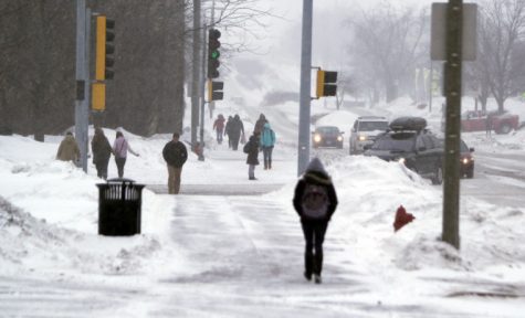 Students walk to class along Normal Road during a snow storm.