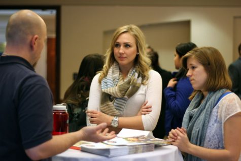 Senior marketing major Laine Smid (left) and sophomore accountancy major Chloe Pooler (right) converse with Rok Teasley of the Peace Corps Monday at Careers for a CAUSE. The Peace Corps was one of several organizations and businesses that attended Careers for a CAUSE at the Barsema Alumni & Visitor’s Center. The event encouraged students to attend so they could network with companies and executives.