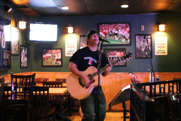 Luke Underhill, Yorkville High School senior and co-host of open mic night, sings and plays acoustic guitar Monday at Fatty’s Pub, 1312 W. Lincoln Highway.