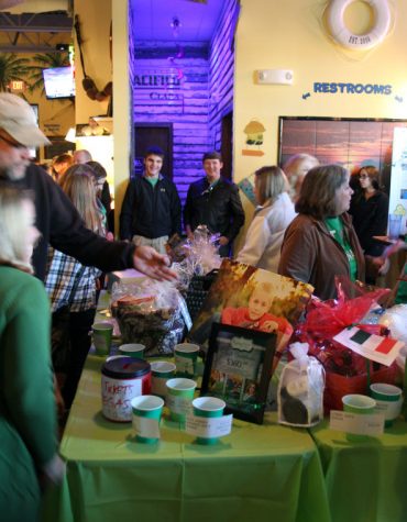 A man donates at the Canaday Family Benefit hosted by Cabana Charley’s, 1470 S. Peace Road in Sycamore, Monday. The event was held to raise money for Christopher Canaday, who has battled pulmonary atresia, and his father, Mark Canaday, who is fighting esophageal cancer. The event was coordinated by Jen Montavon and Ali Henry, a P.E. teacher and a teaching assistant, respectively, at Clinton Rosette Middle School, which Christopher Canaday attends.