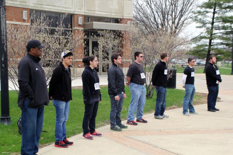 Members of Alpha Epsilon Pi and B’nai B’rith International stand in silence in remembrance of the victims of the Holocaust Monday in front of Cole Hall.