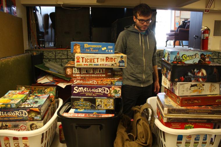 Dustin Coy, 29, of DeKalb, picks out a board game to play during International Tabletop Day at New Game in Town, 811 W. Lincoln Highway. The store had many classic games as well as new games for people to play.