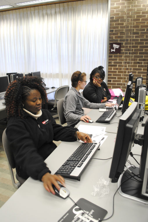 Christianah Olojede, junior rehabilitation service major; Megan Taylor, junior rehab counseling major; and Nicoya Parer, senior public health major, work on a group presentation for their counseling class Thursday in the computer lab of Founders Memorial Library.