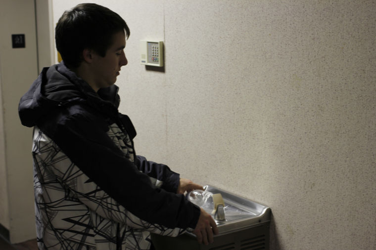 Will Wilson, senior pre-physical therapy major, refills his water bottle from a water fountain in February 2013.