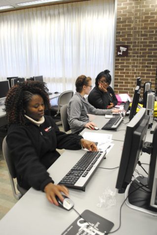 Christianah Olojede, junior rehabilitation service major; Megan Taylor, junior rehab counseling major; and Nicoya Parer, senior public health major, work on a group presentation for their counseling class Thursday in the computer lab of Founders Memorial Library.