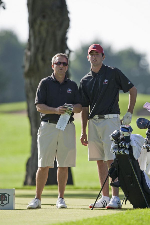 Head coach Tom Porten (left) and freshman golfer Patrick Murphy (right) survey a hole at Rich Harvest Farms in Sugar Grove over the weekend. The Huskies finished in last place at the Northern Intercollegiate, and Murphy carded an (80, 75, 85, 240) in the three-day tournament.