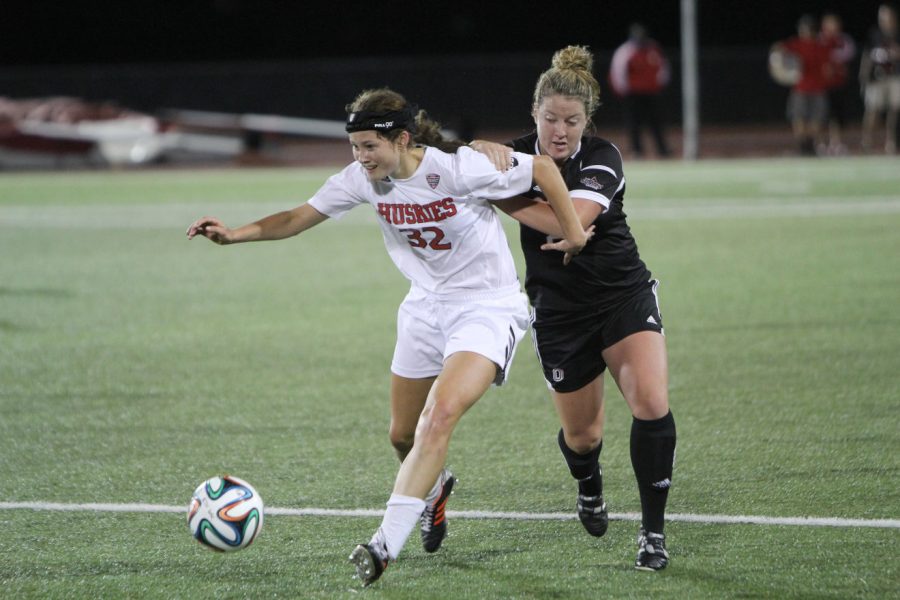 Sophomore Jess Wooldridge fends off an attacker in women’s soccer’s 1-0 win over Nebraska-Omaha Friday. The Huskies’ defense has only allowed .77 goals per game at home since the beginning of the 2013 season.