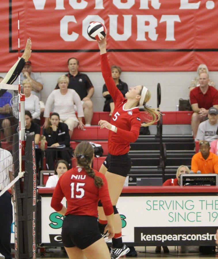Sophomore middle blocker Jenna Radtke (5) spikes the ball against the Colorado Buffaloes Aug. 30 at Victor E. Court. Radtke has excelled on the defensive side of the ball but is working to improve her entire game.