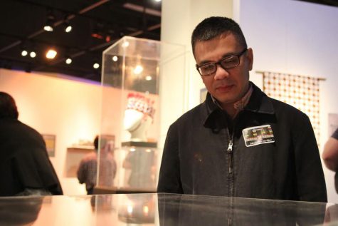 Hao Phan, University Libraries' Southeast Asia curator, views an exhibit on an early 20th century Potlatch Spoon during Tuesday's 50th anniversary of the NIU Anthropology Museum.