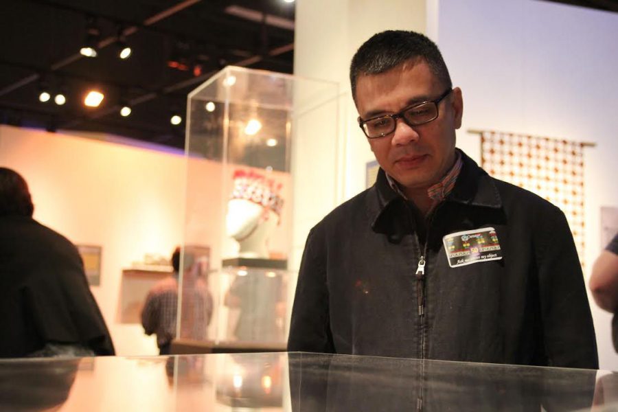 Hao Phan, University Libraries Southeast Asia curator, views an exhibit on an early 20th century Potlatch Spoon during Tuesdays 50th anniversary of the NIU Anthropology Museum.